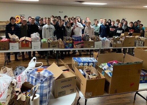 group of people behind tables of boxes